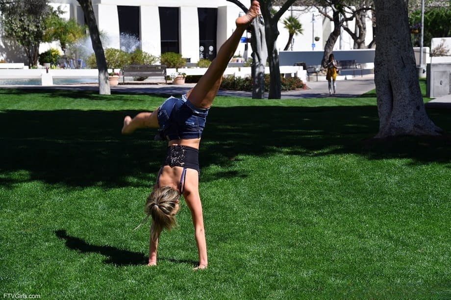 Cute blonde Athena does a cartwheel in shorts during non-nude action in public