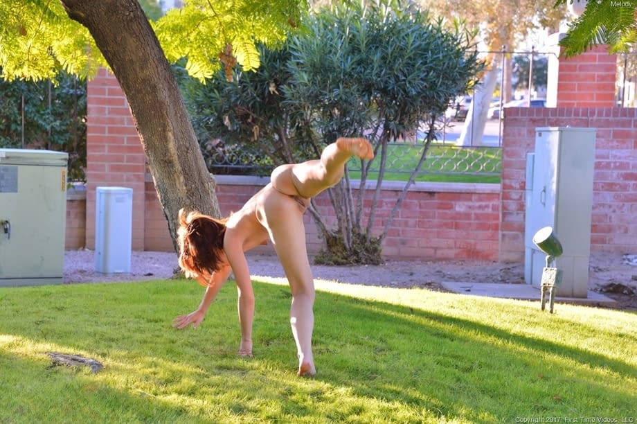 Brunette teen Melody doffs her clothes and masturbates with her hand outdoors