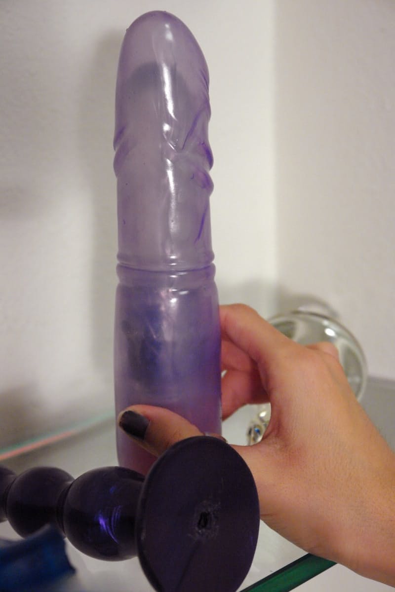 Bored waitress Sasha Grey tries out sex toys in the back room at work