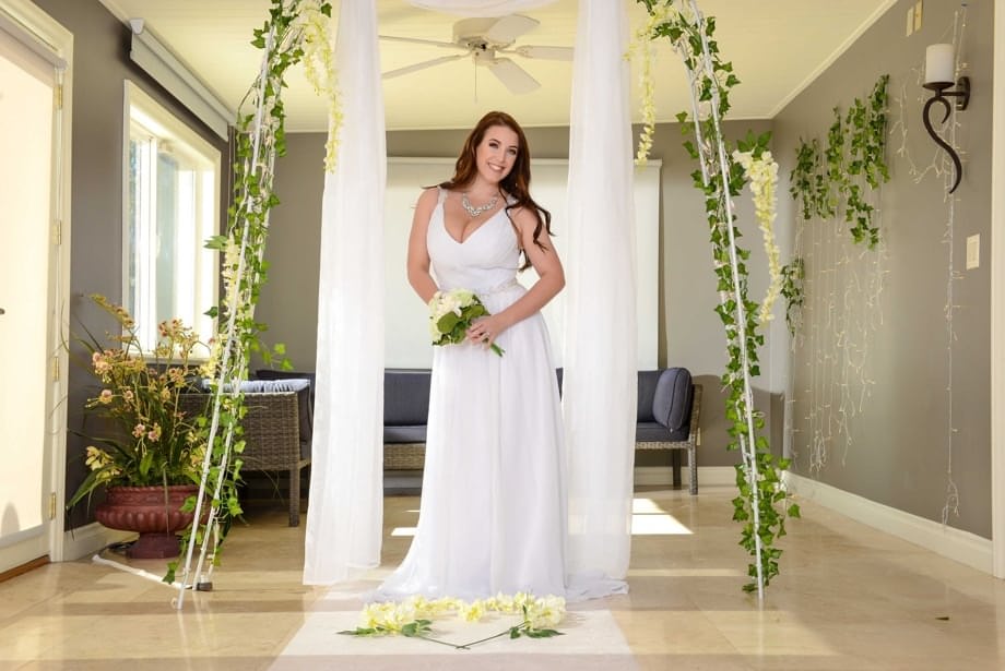 Buxom bride Angela White lets out her huge breasts and flashes her fat ass