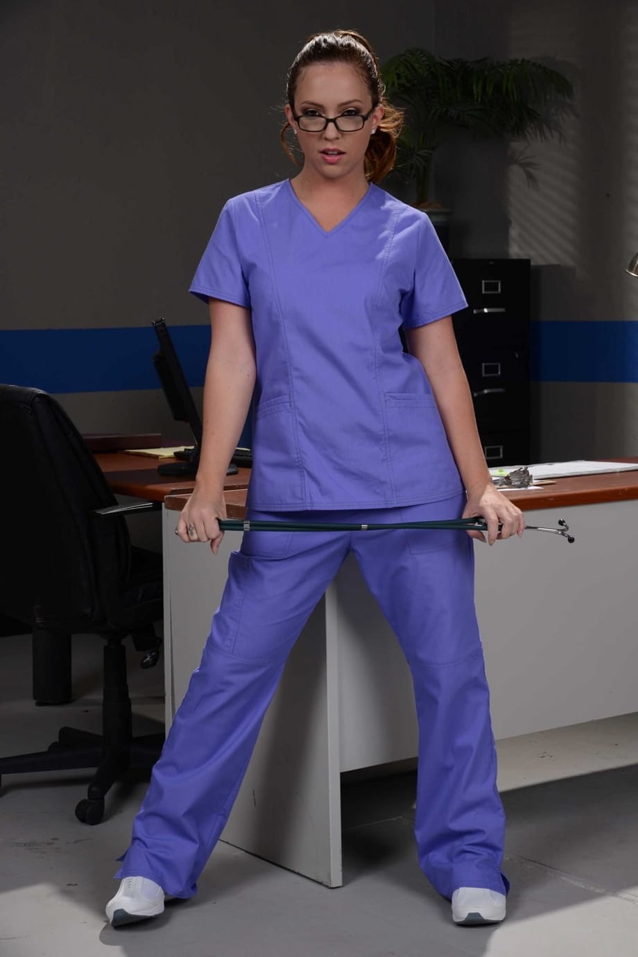 Glasses clad nurse Maddy Oreilly takes off her uniform while at work