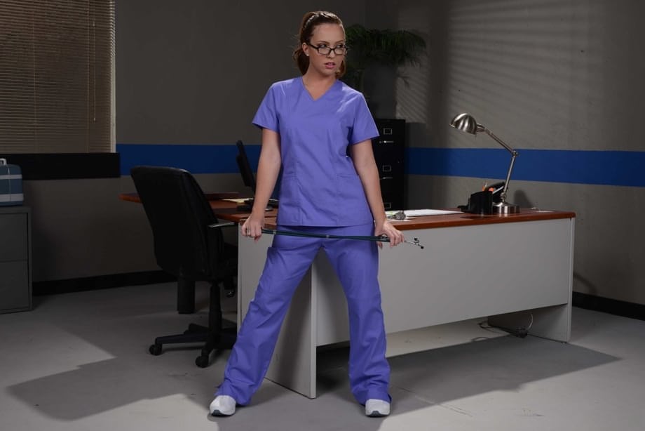 Glasses clad nurse Maddy Oreilly takes off her uniform while at work