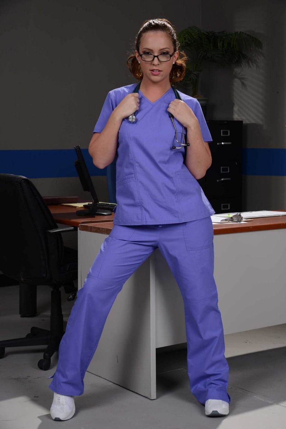 Glasses clad nurse Maddy Oreilly takes off her uniform while at work