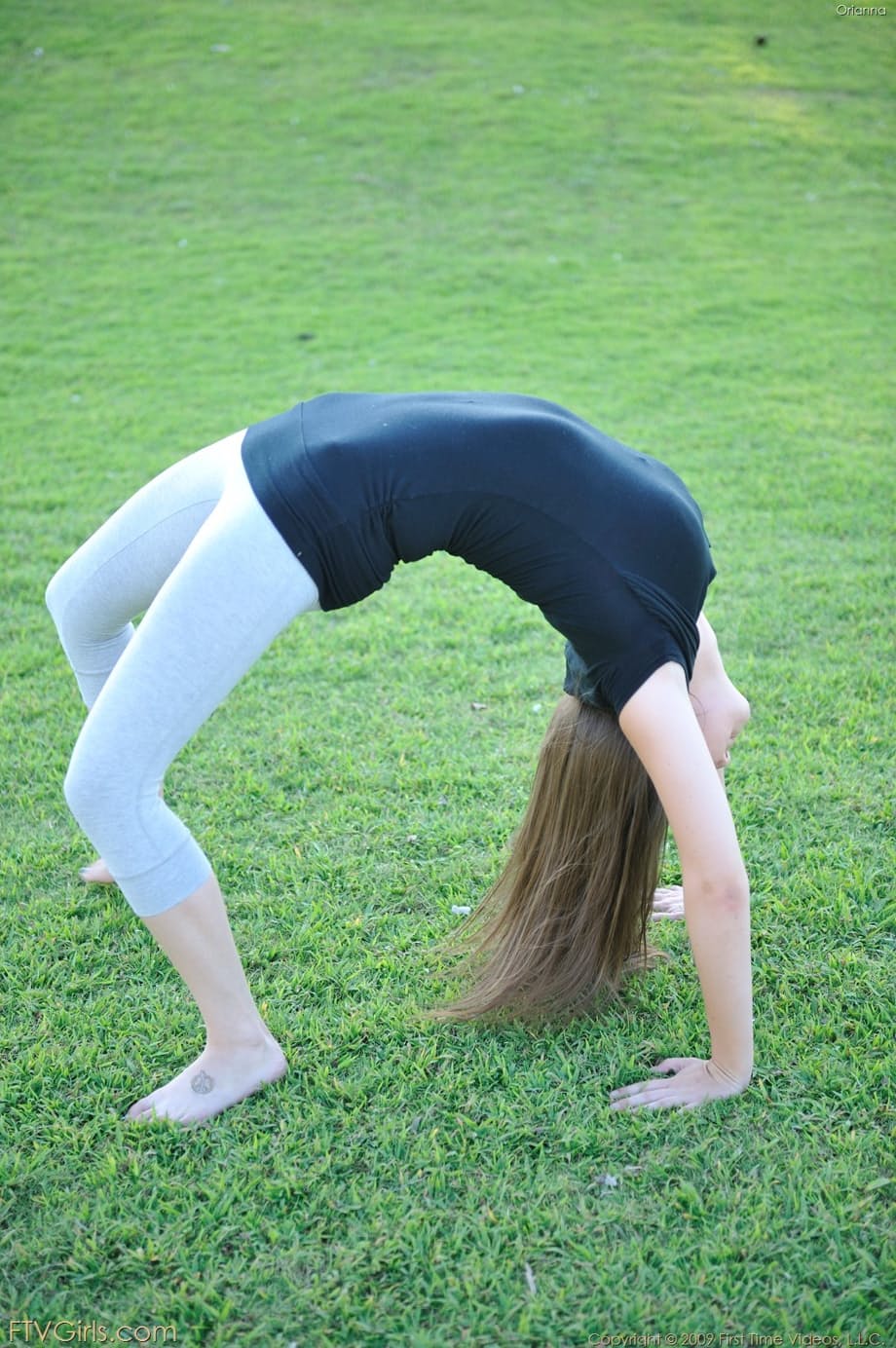 Amateur cutie with glasses Orianna gets naked while doing exercises outdoors