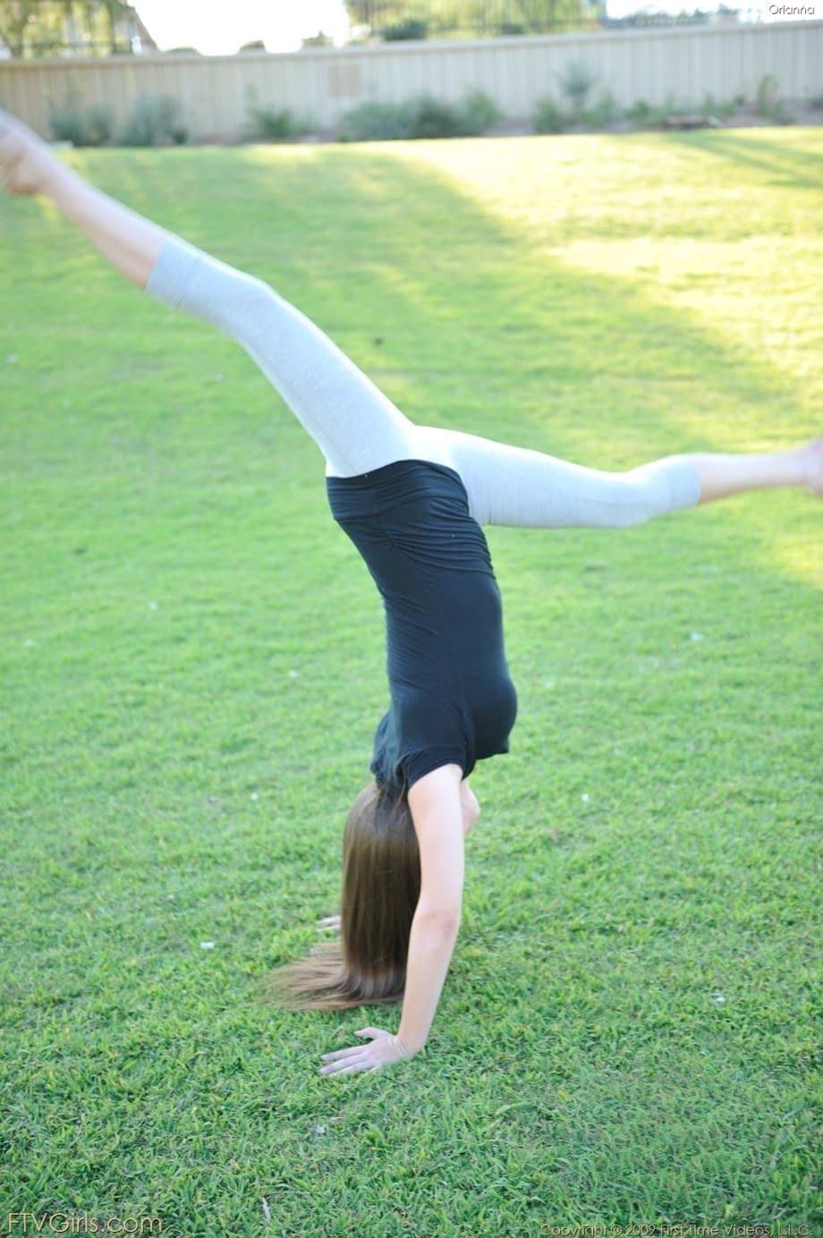 Amateur cutie with glasses Orianna gets naked while doing exercises outdoors