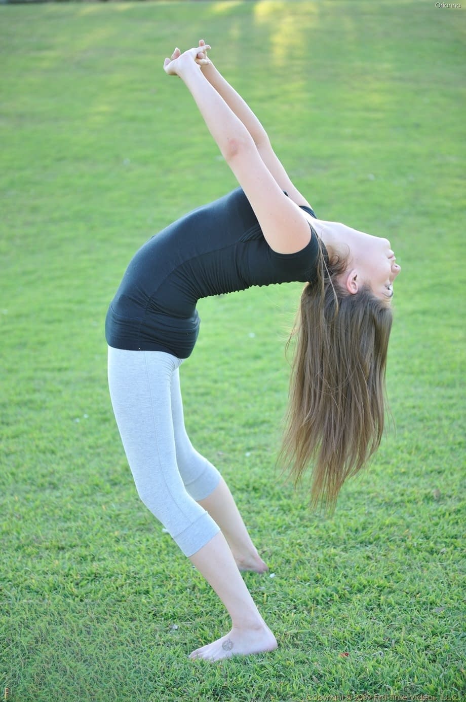 Amateur cutie with glasses Orianna gets naked while doing exercises outdoors