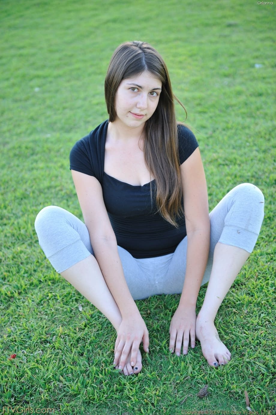 Amateur cutie with glasses Orianna gets naked while doing exercises outdoors