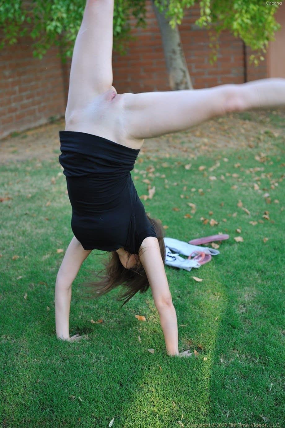 Amateur cutie with glasses Orianna gets naked while doing exercises outdoors