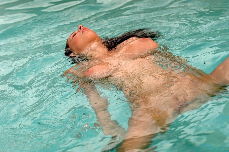 Adorable pornstar Gianna Michaels plays with her big boobs & a toy in the pool