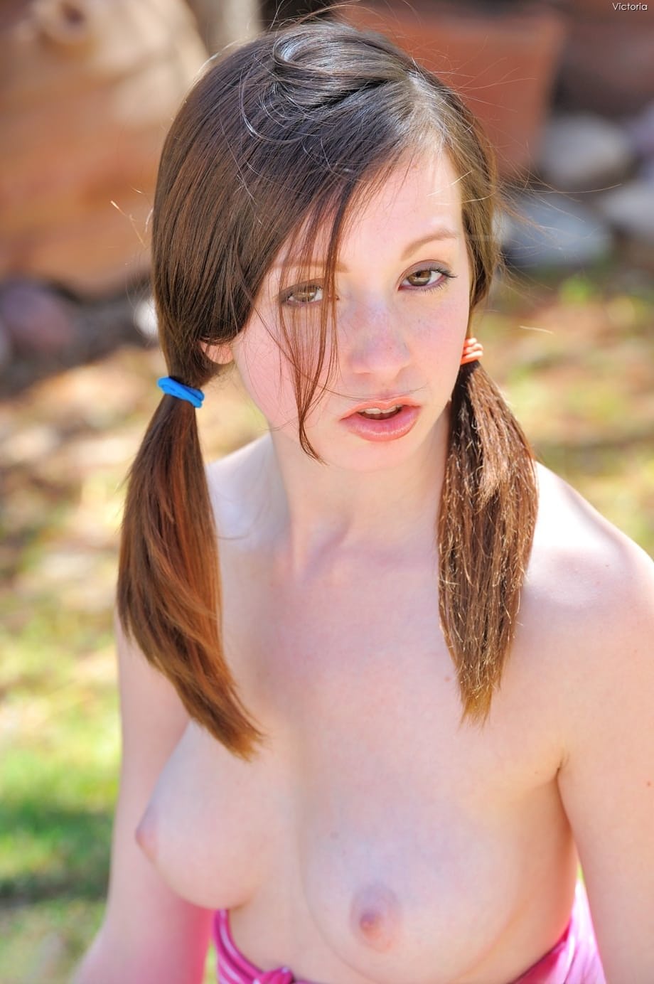 Teen with pigtails Victoria reveals her nice tits & plays with a water hose