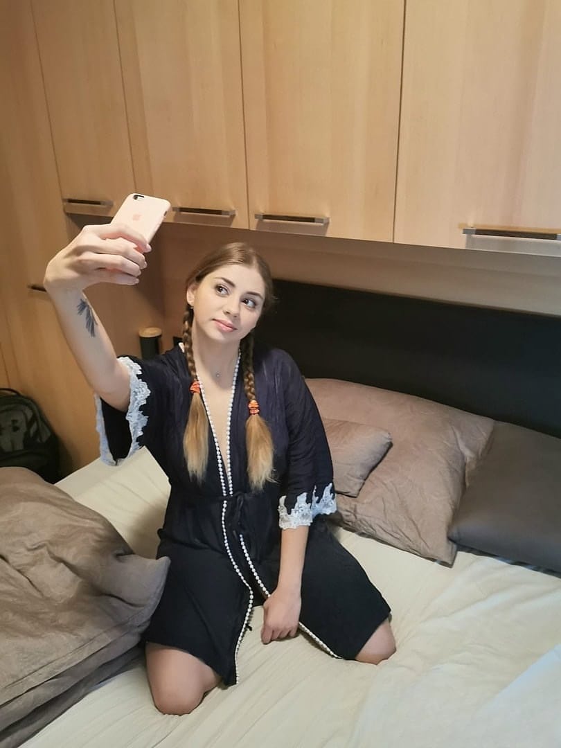 Russian babe Julia Red shows her perky tits and spreads her shaved pussy
