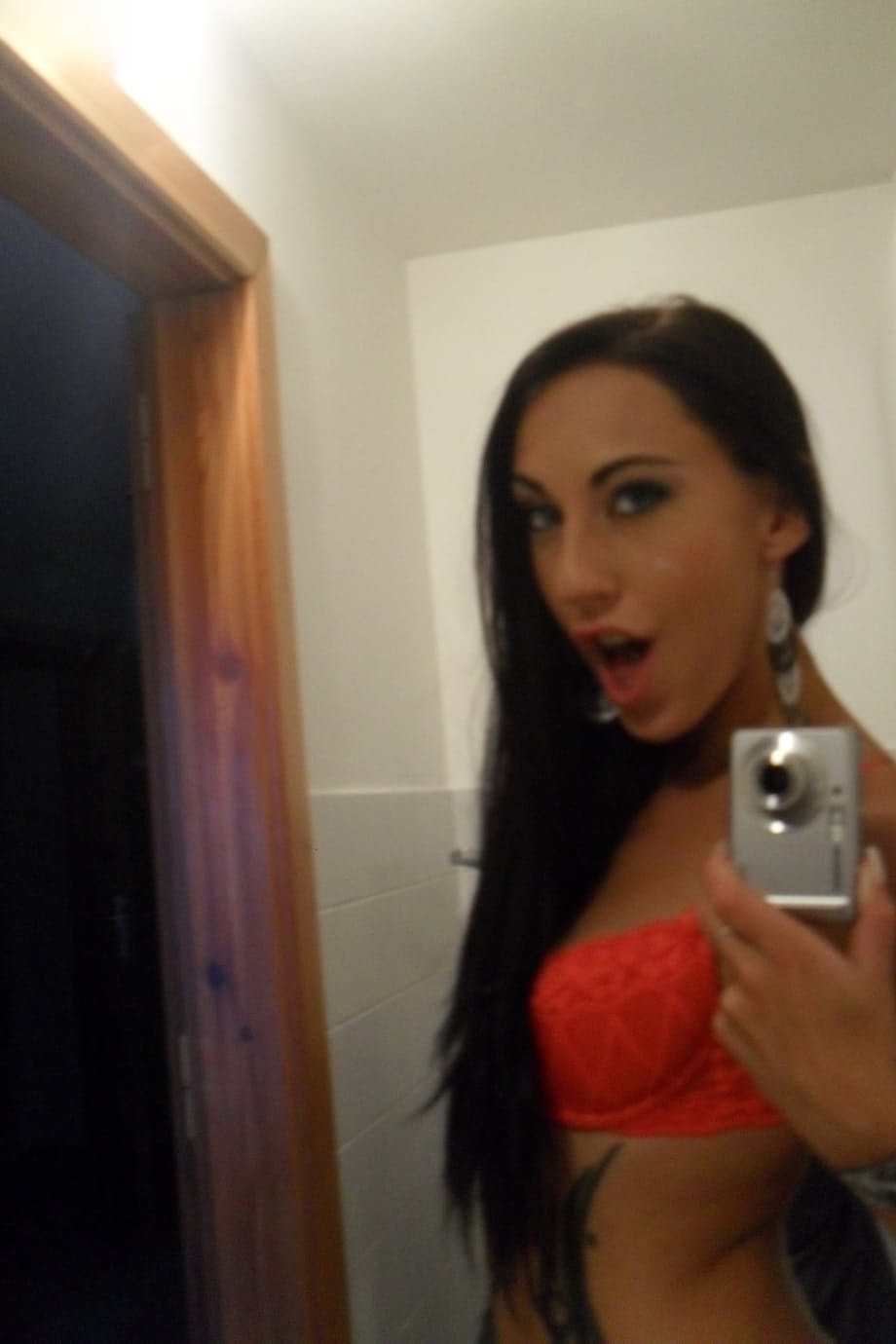 Teen with an inked body Ella Storm takes selfies while stripping in the mirror