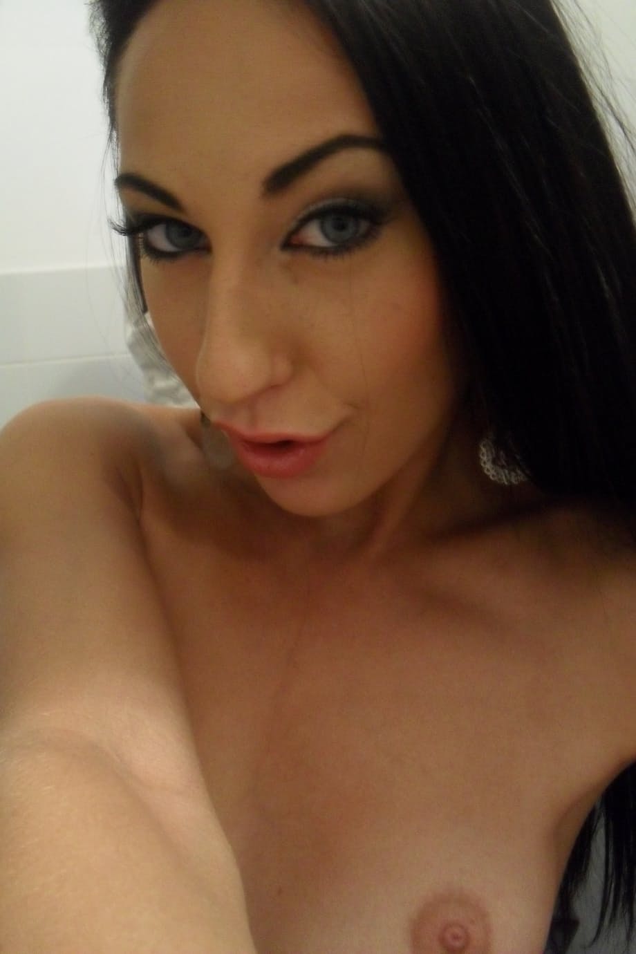 Teen with an inked body Ella Storm takes selfies while stripping in the mirror